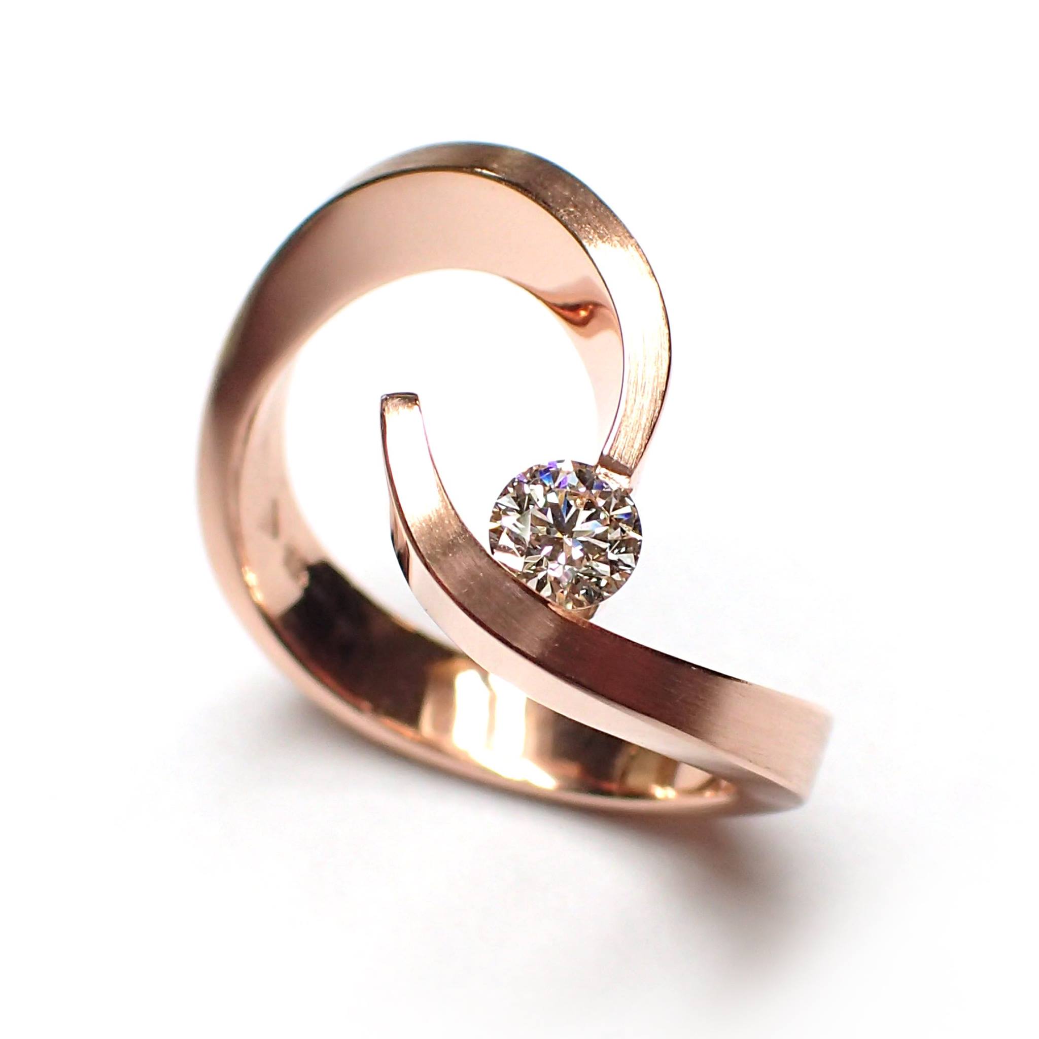 artistic 18 carat rose gold ring with a brilliant cut diamond