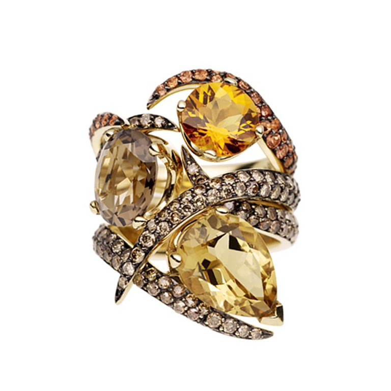 Three 18 karat yellow gold rings set with quartz, diamonds and sapphires, all in yellow and brown tones. The three rings can be combined to form one wide ring.