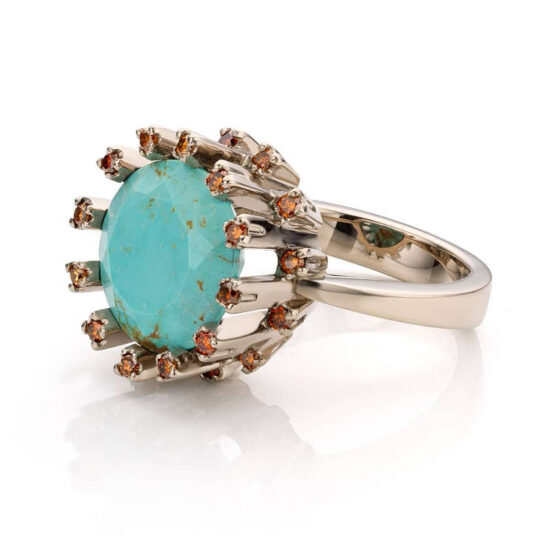 18 karat white gold ring, with a turquoise centre stone surrounded with matching cognac diamonds.