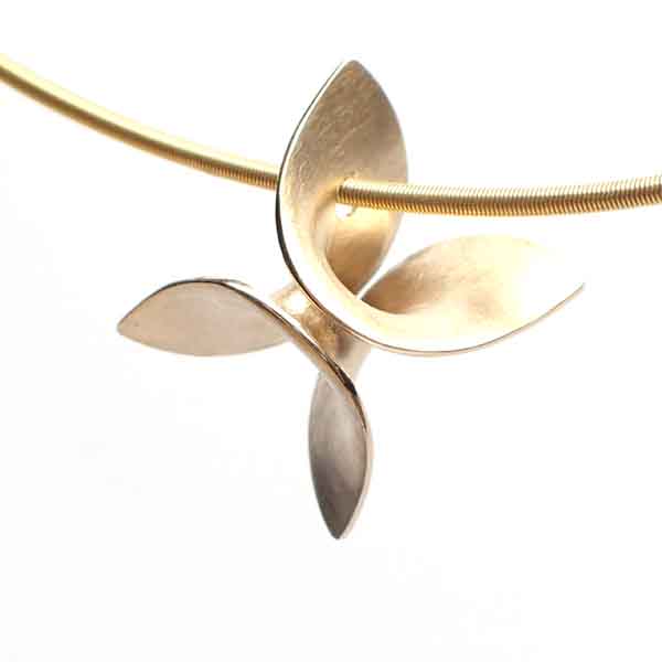 A beautifully shaped 18 karat gold pendant, which could pass for an abstract four-leaf clover.