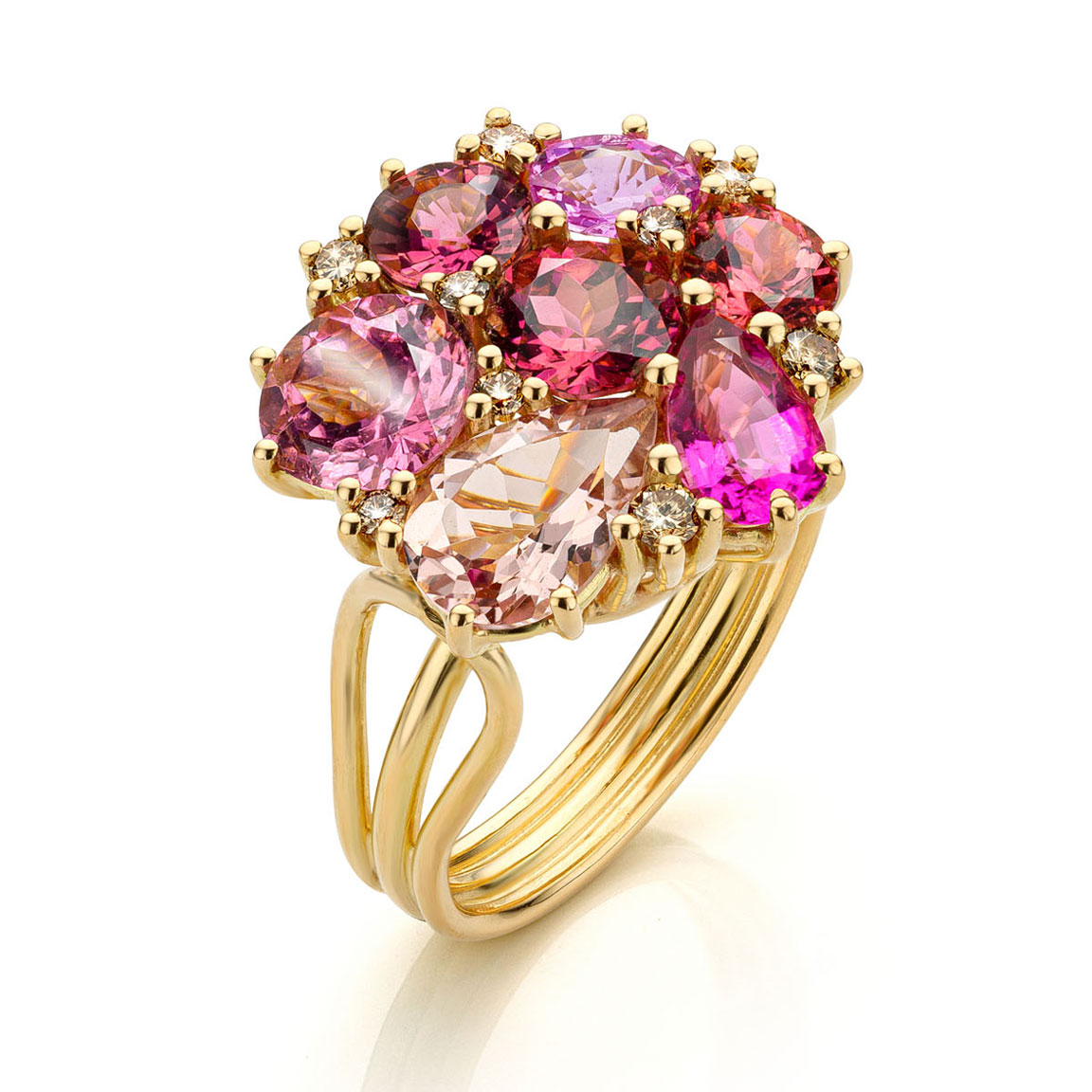 18 karat yellow gold ring with five pink tourmalines, one pink sapphire and one pink morganite and small brown diamonds.