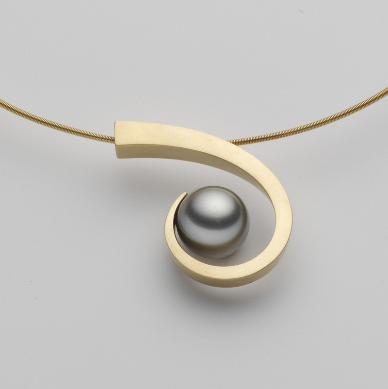 18 karat yellow gold designer pendant consisting of an elegant swirl around a natural grey Tahitian pearl.